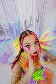 Woman in rave outfit with clown makeup